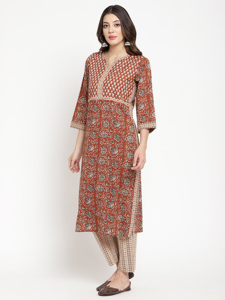 Woman posing in Savi's Cotton Block Printed rust beige Kurta with Pant