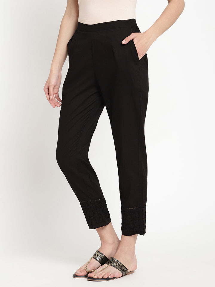 Wide shot of black cotton pintuck pants for women.