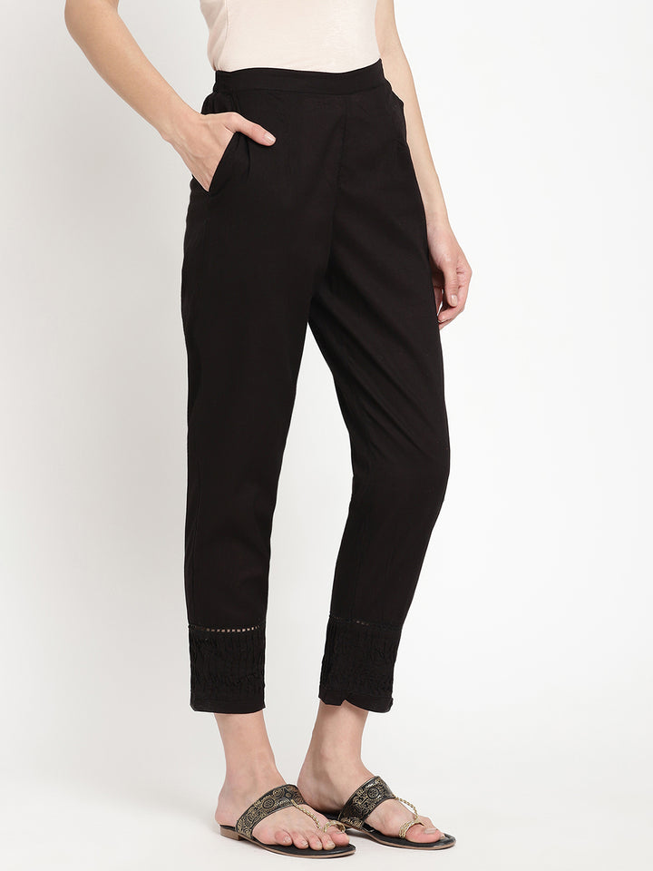 Wide shot of black cotton pintuck pants for women.