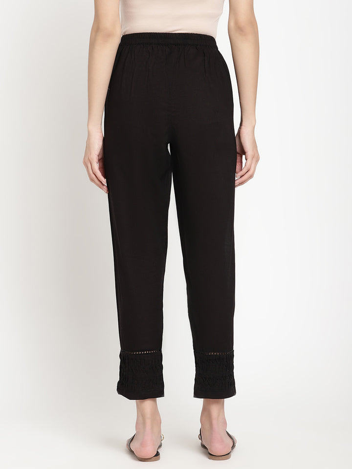Wide shot of black cotton pintuck pants for women.