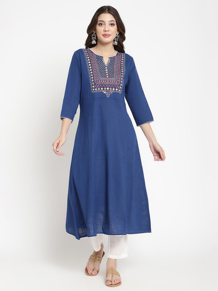 Woman posing in a blue embroidered Kurta by Savi.