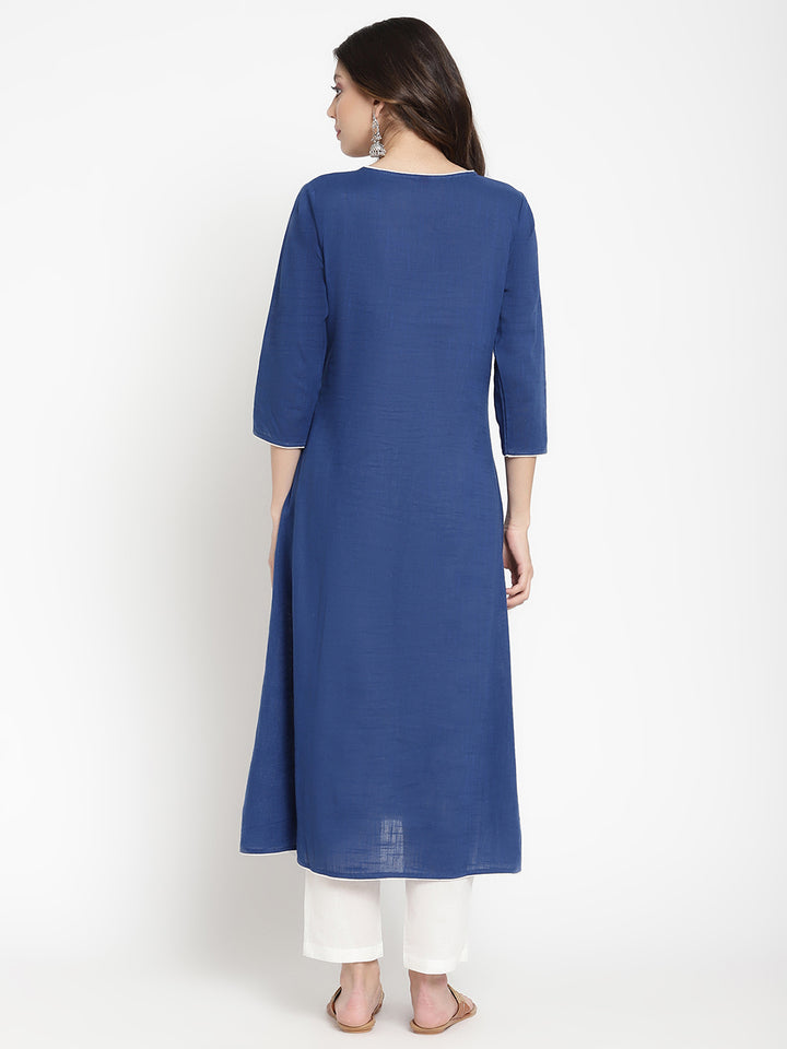 Woman posing in a blue embroidered Kurta by Savi.