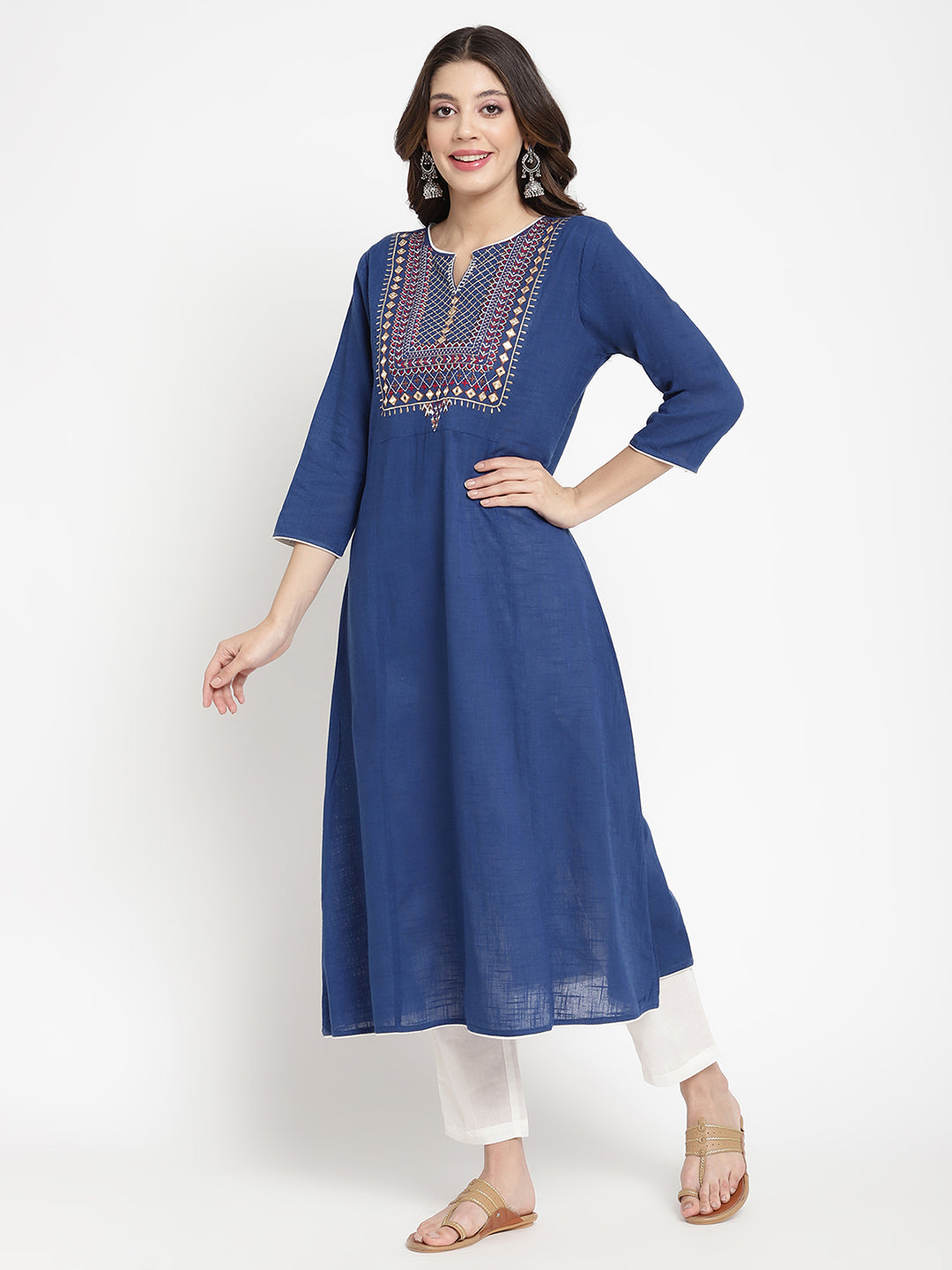 Woman posing in a blue embroidered Kurta by Savi.