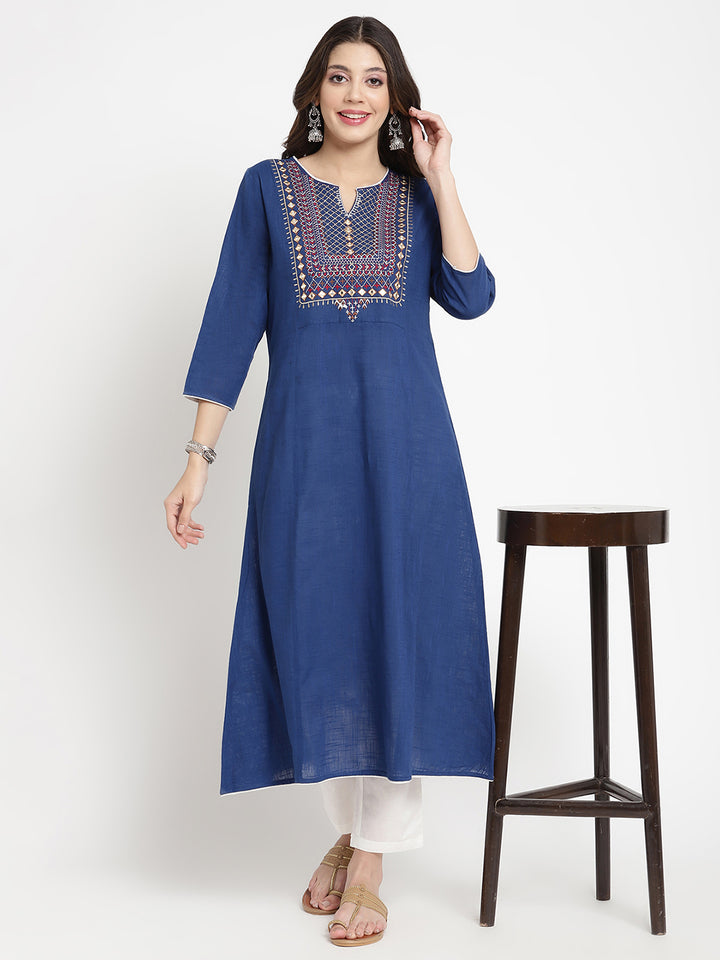 Woman posing in a blue embroidered Kurta by Savi.