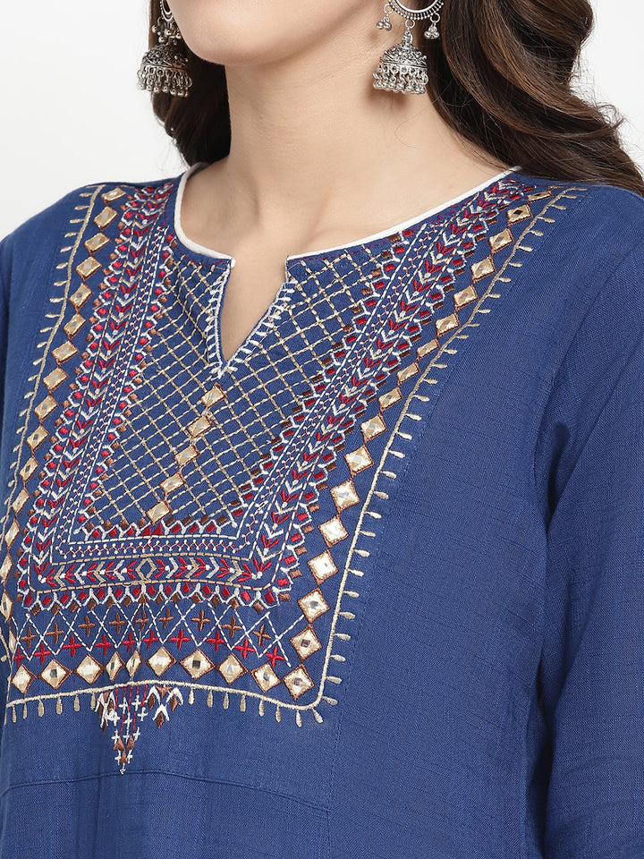 Woman posing in a blue embroidered Kurta by Savi.