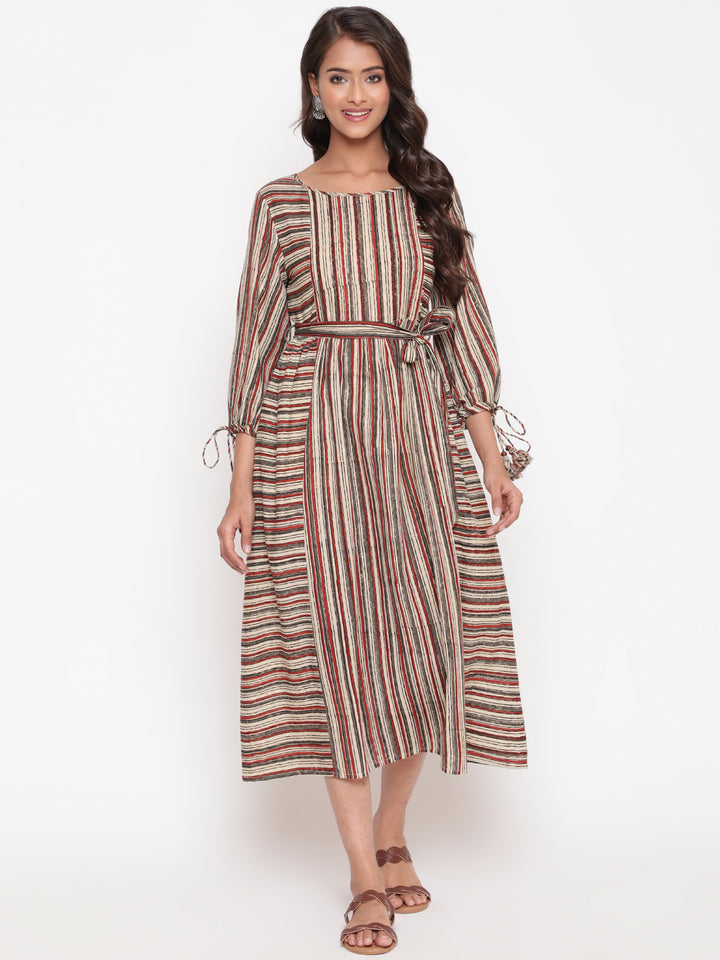 Woman posing in Savi's Cotton Block Printed tie up striped rust calf length dress