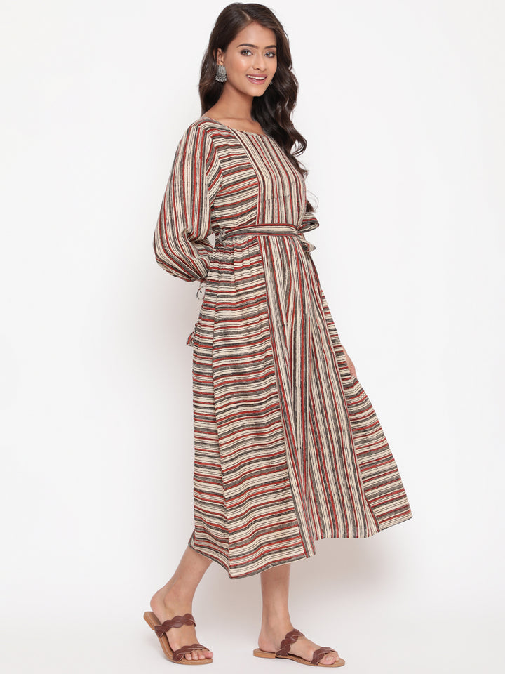 Woman posing in Savi's Cotton Block Printed tie up striped rust calf length dress