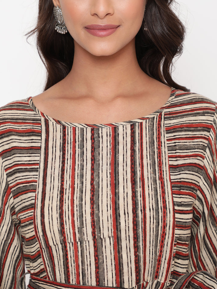Woman posing in Savi's Cotton Block Printed tie up striped rust calf length dress