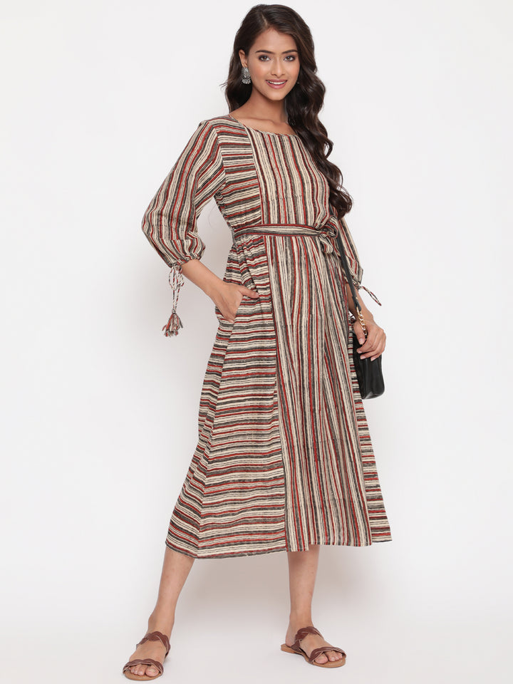 Woman posing in Savi's Cotton Block Printed tie up striped rust calf length dress