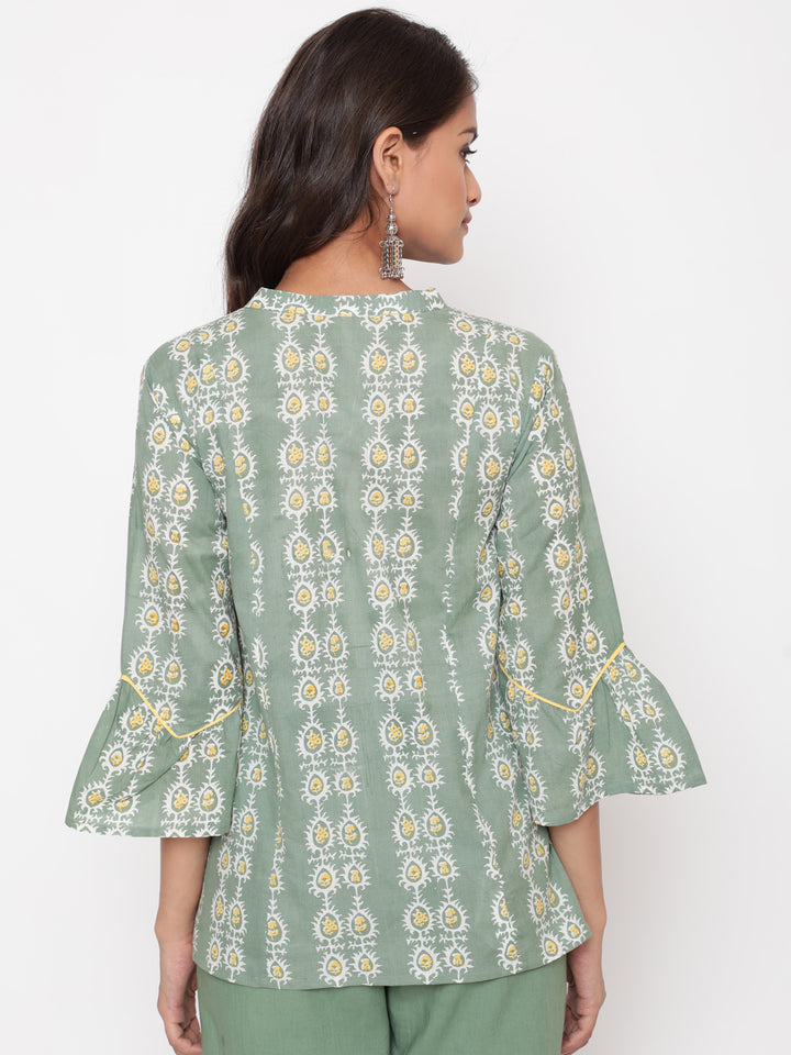 Woman posing in Savi's Cotton Printed Sage green flared sleeveless top.