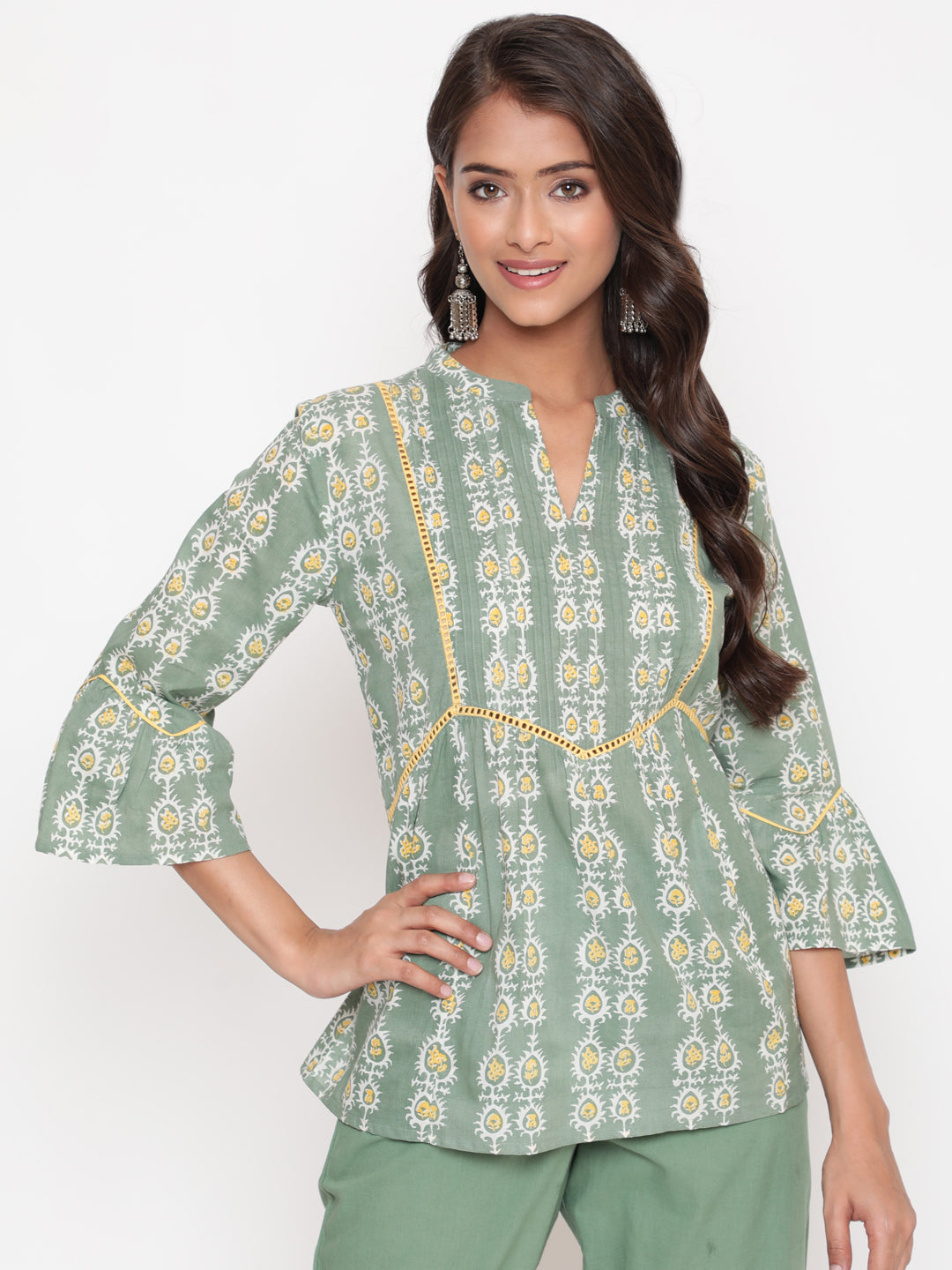 Woman posing in Savi's Cotton Printed Sage green flared sleeveless top.