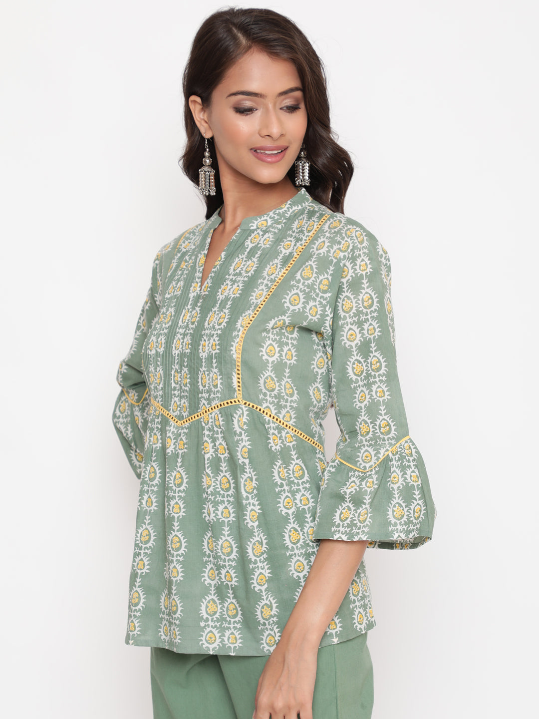 Woman posing in Savi's Cotton Printed Sage green flared sleeveless top.