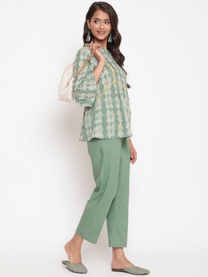 Woman posing in Savi's Cotton Printed Sage green flared sleeveless top.