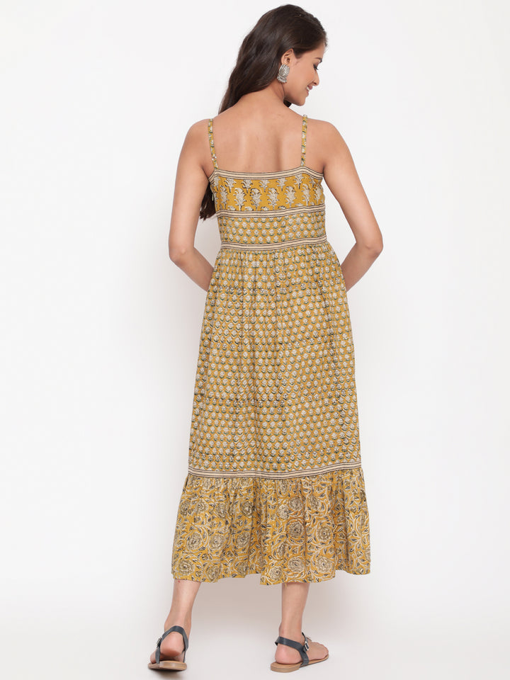 Woman posing in Savi's Cotton hand block inspired printed strappy mustard flared dress