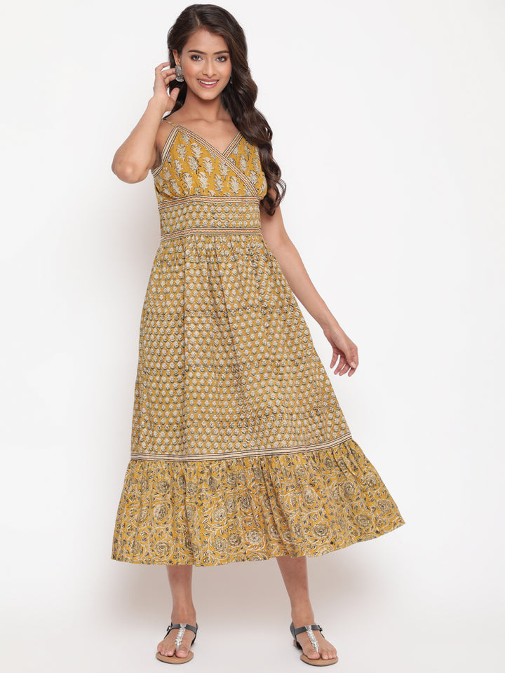 Woman posing in Savi's Cotton hand block inspired printed strappy mustard flared dress