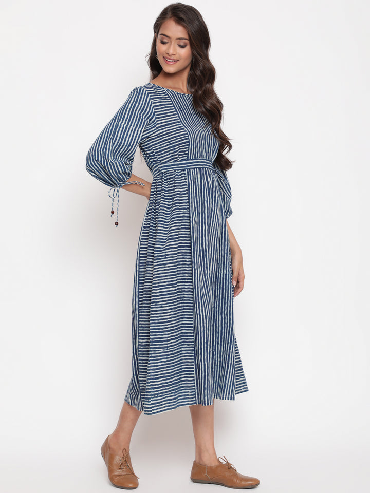 Woman posing in Savi's Cotton indigo Printed Striped Tie up designer Dress