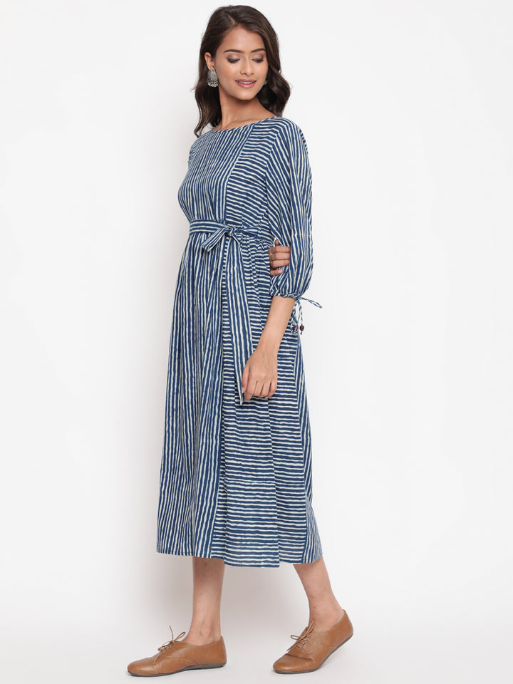 Woman posing in Savi's Cotton indigo Printed Striped Tie up designer Dress