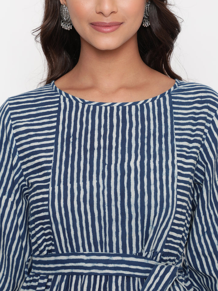 Woman posing in Savi's Cotton indigo Printed Striped Tie up designer Dress