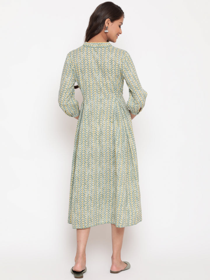 Woman posing in Savi's Cotton overlap Yoke sage Green Pleated Dress