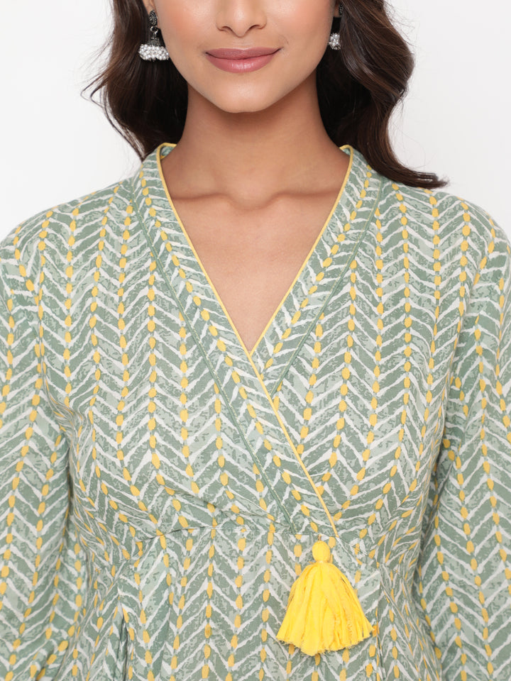 Woman posing in Savi's Cotton overlap Yoke sage Green Pleated Dress