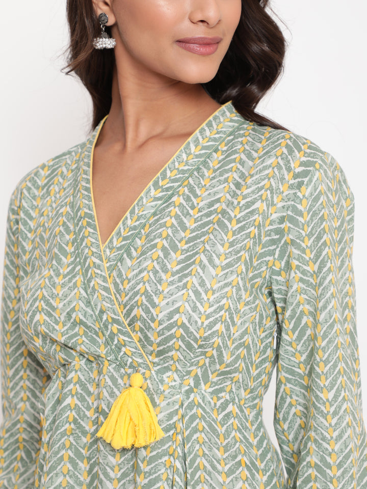 Woman posing in Savi's Cotton overlap Yoke sage Green Pleated Dress