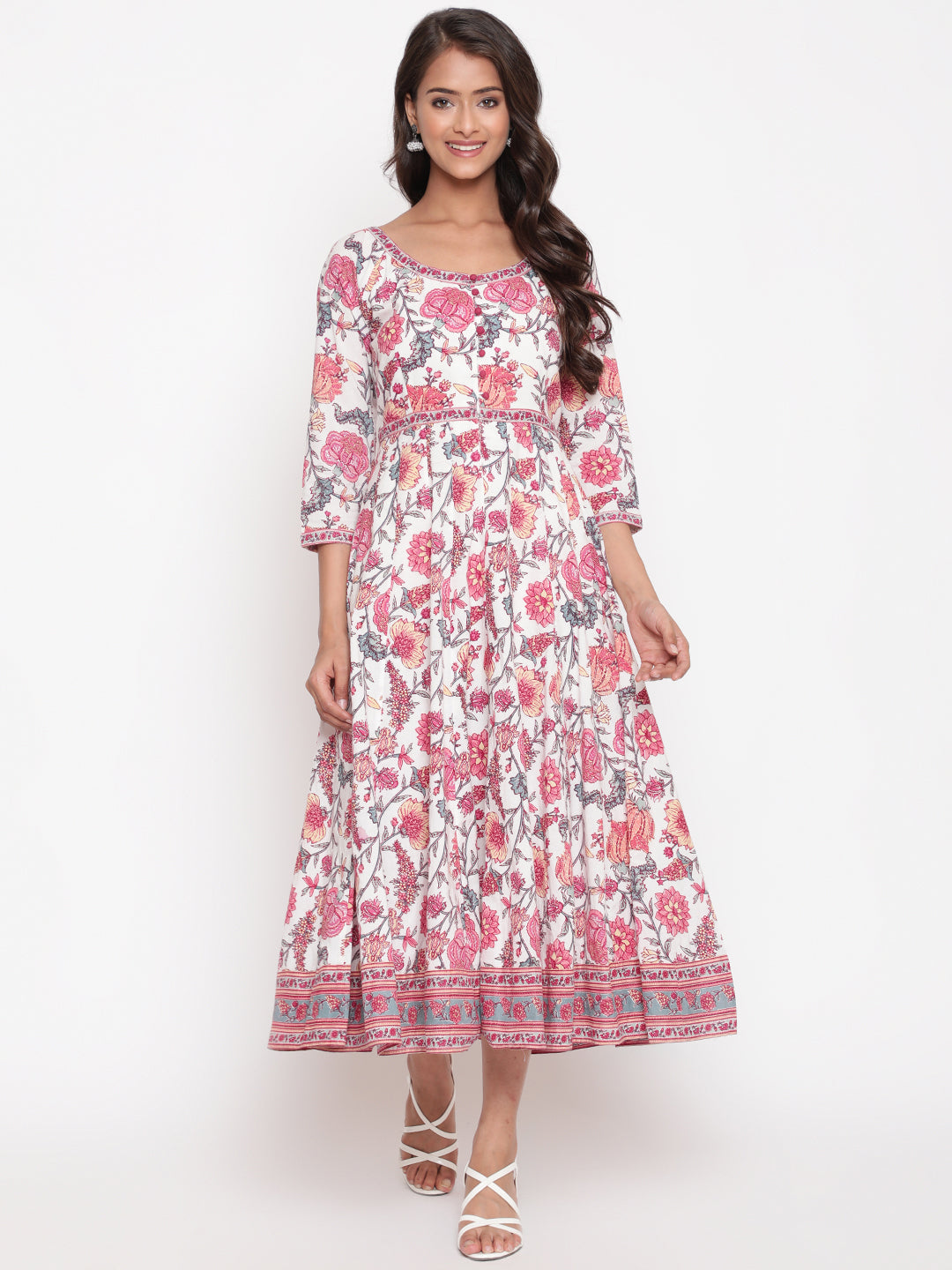 Woman posing in Savi's White Cotton Floral Flared Long DressWoman posing in Savi's White Cotton Floral Flared Long Dress