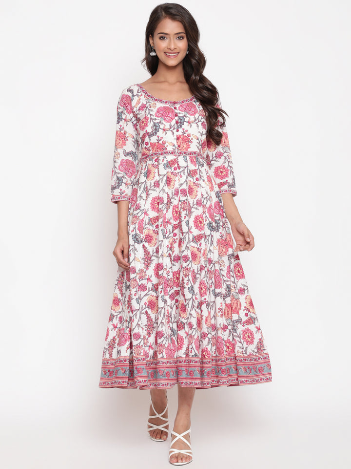 Woman posing in Savi's White Cotton Floral Flared Long DressWoman posing in Savi's White Cotton Floral Flared Long Dress