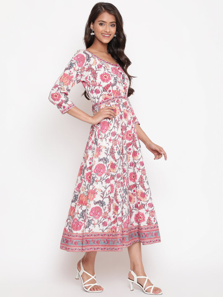 Woman posing in Savi's White Cotton Floral Flared Long Dress
