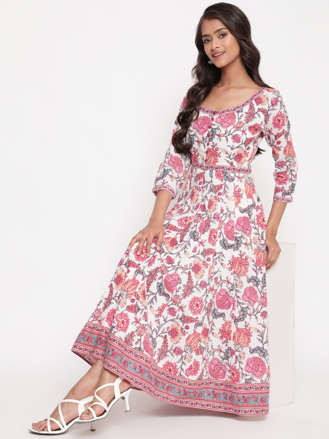 Woman posing in Savi's White Cotton Floral Flared Long Dress