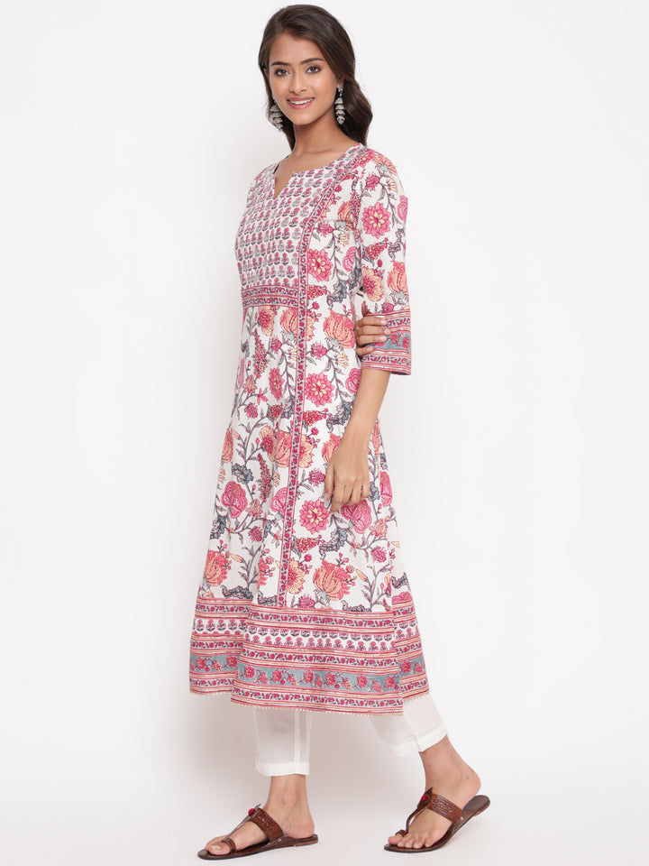 Woman posing in Savi's Pink Cotton Floral Printed Embellished Flared Kurta