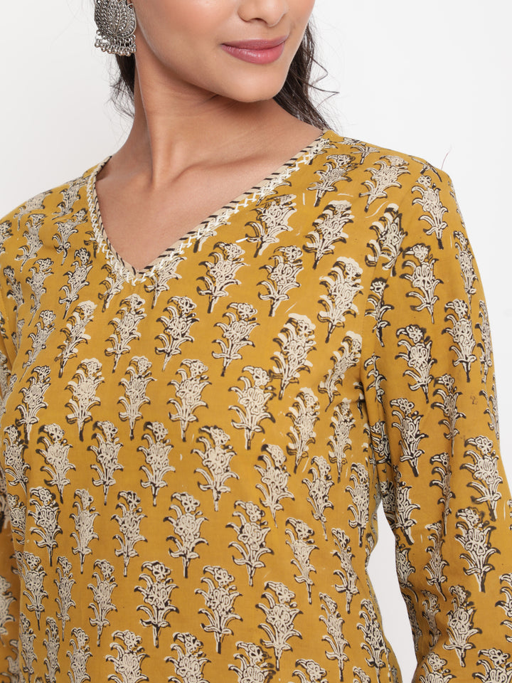 Woman posing in Savi's Cotton Printed Yellow Kurta Pant set