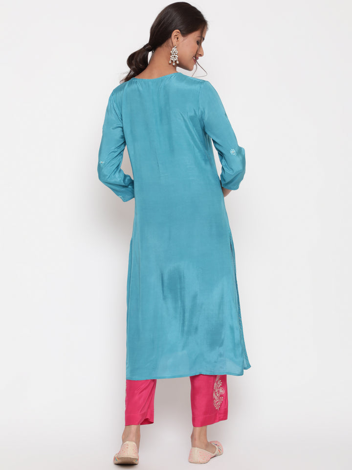 Woman posing in Savi’s Shantoon Embroidered straight Blue Kurta with Pink Pant