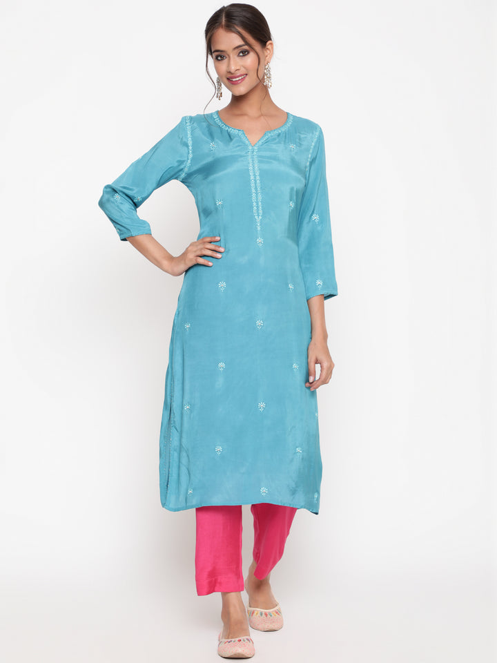 Woman posing in Savi’s Shantoon Embroidered straight Blue Kurta with Pink Pant