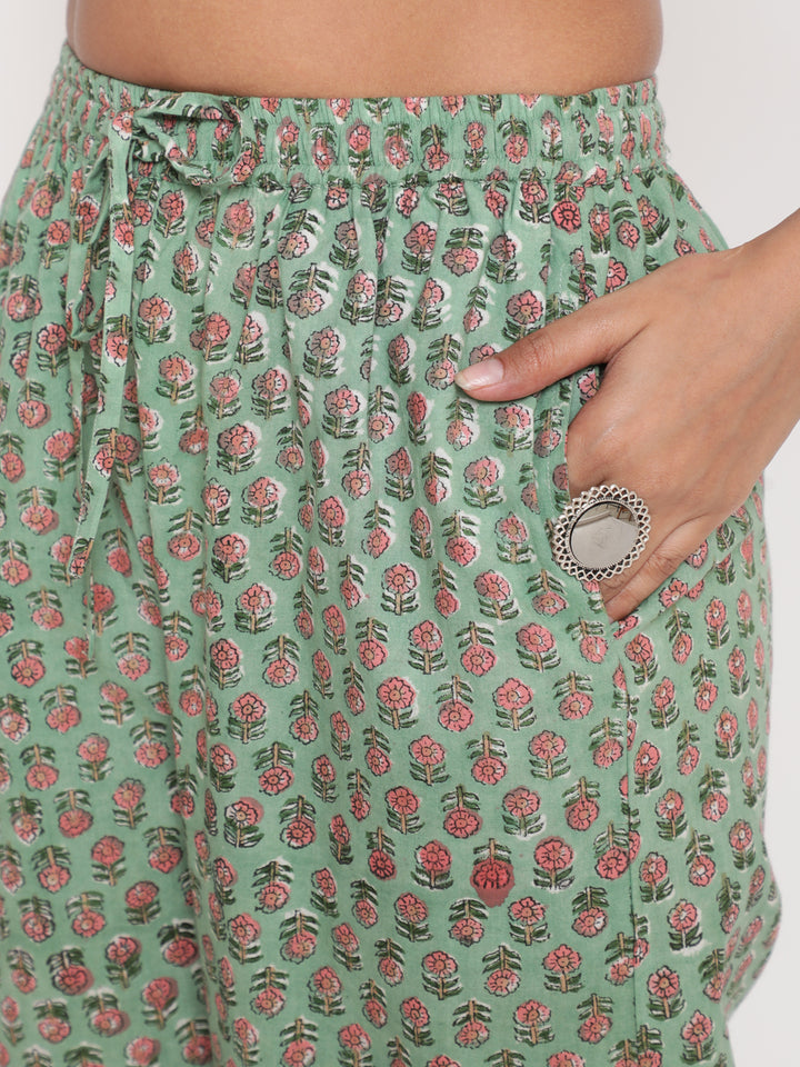 Woman posing in Savi's Cotton Embellished Sage Green A Line Flared Kurta pant Set