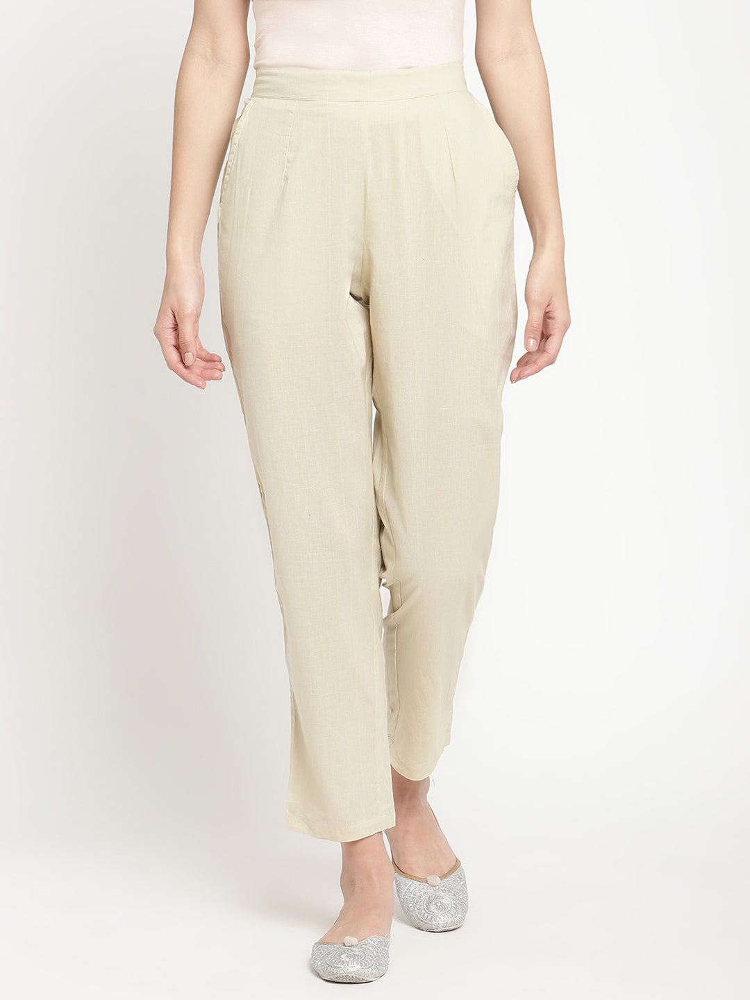 Full shot of straight-fit, off-white pants for women.