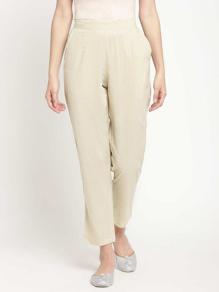 Full shot of straight-fit, off-white pants for women.