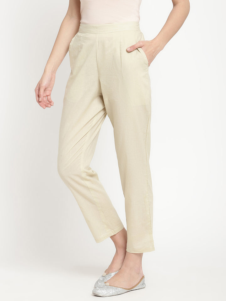 Full shot of straight-fit, off-white pants for women.