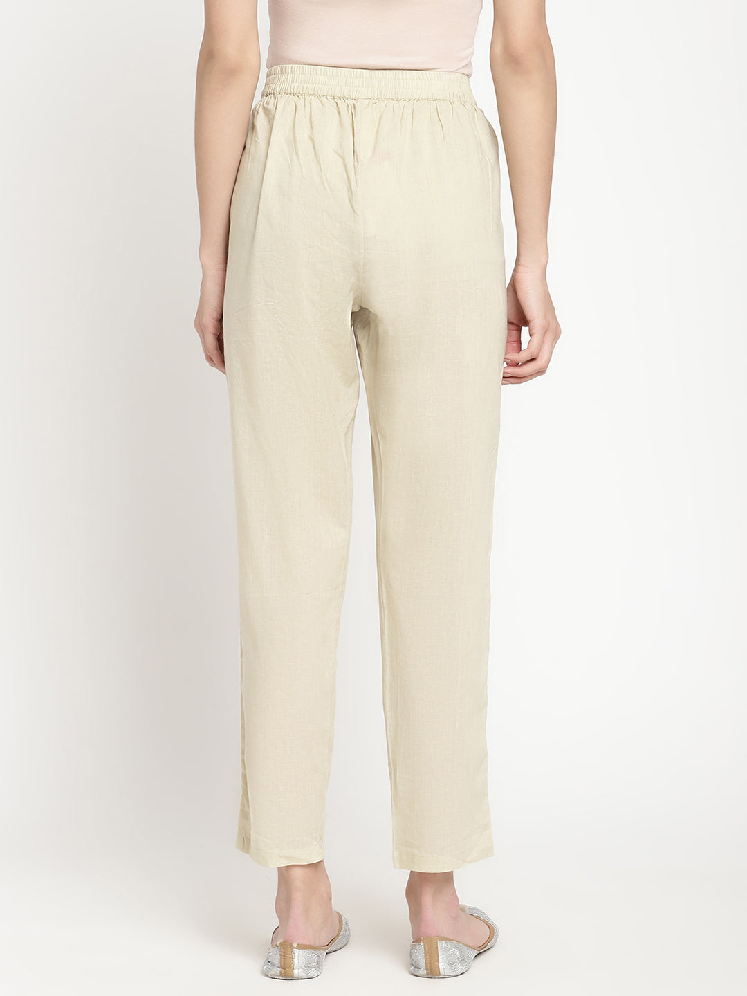 Full shot of straight-fit, off-white pants for women.