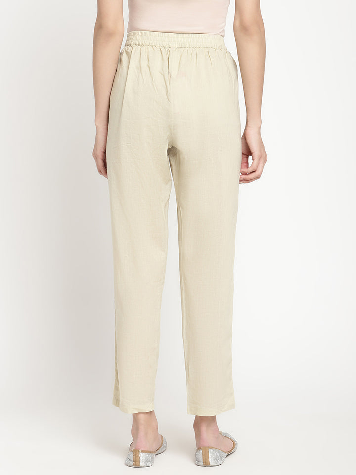 Full shot of straight-fit, off-white pants for women.