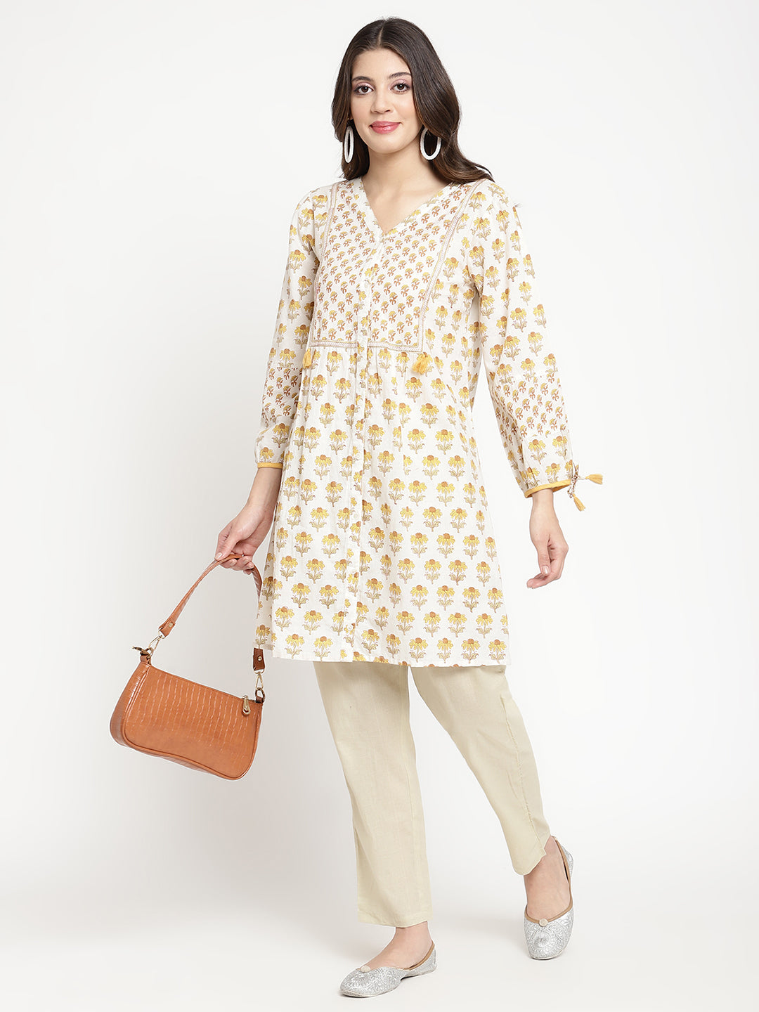 Full shot of straight-fit, off-white pants for women.