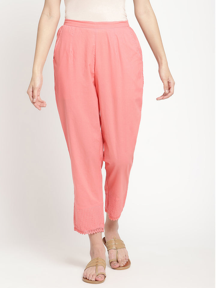 Model wearing pink cotton straight fit pants.