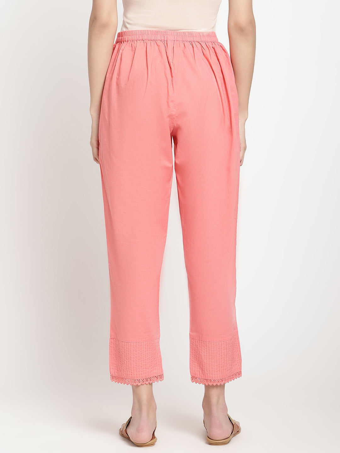 Model wearing pink cotton straight fit pants.