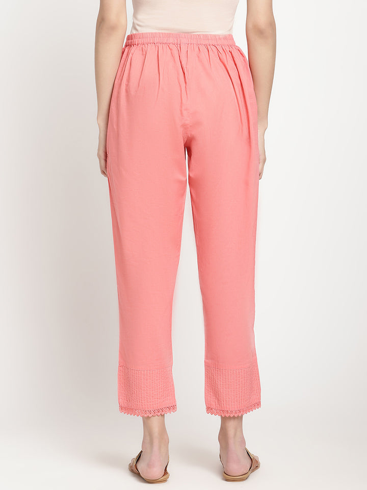 Model wearing pink cotton straight fit pants.