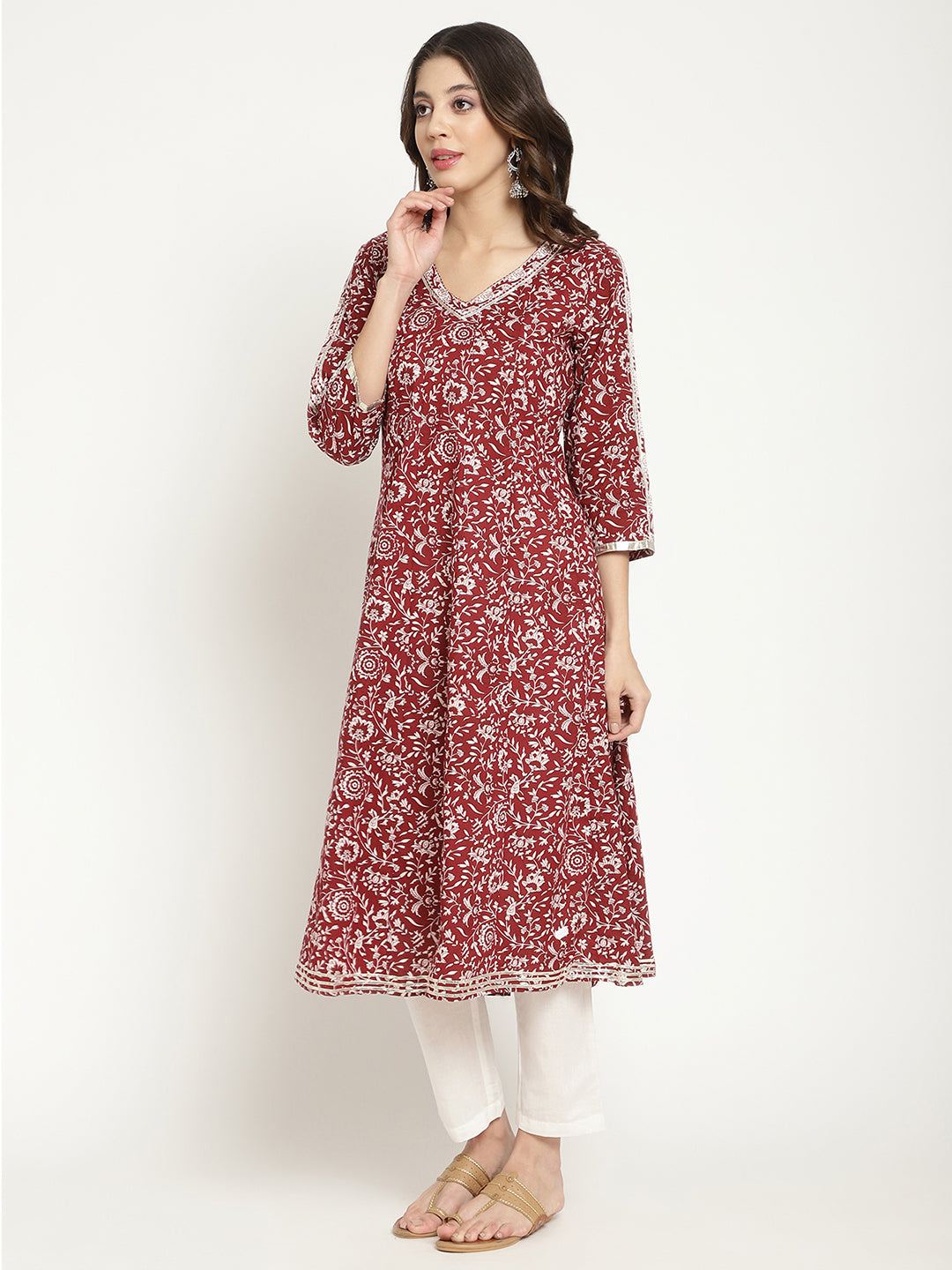 Woman posing in a flared Kurta against a white background.