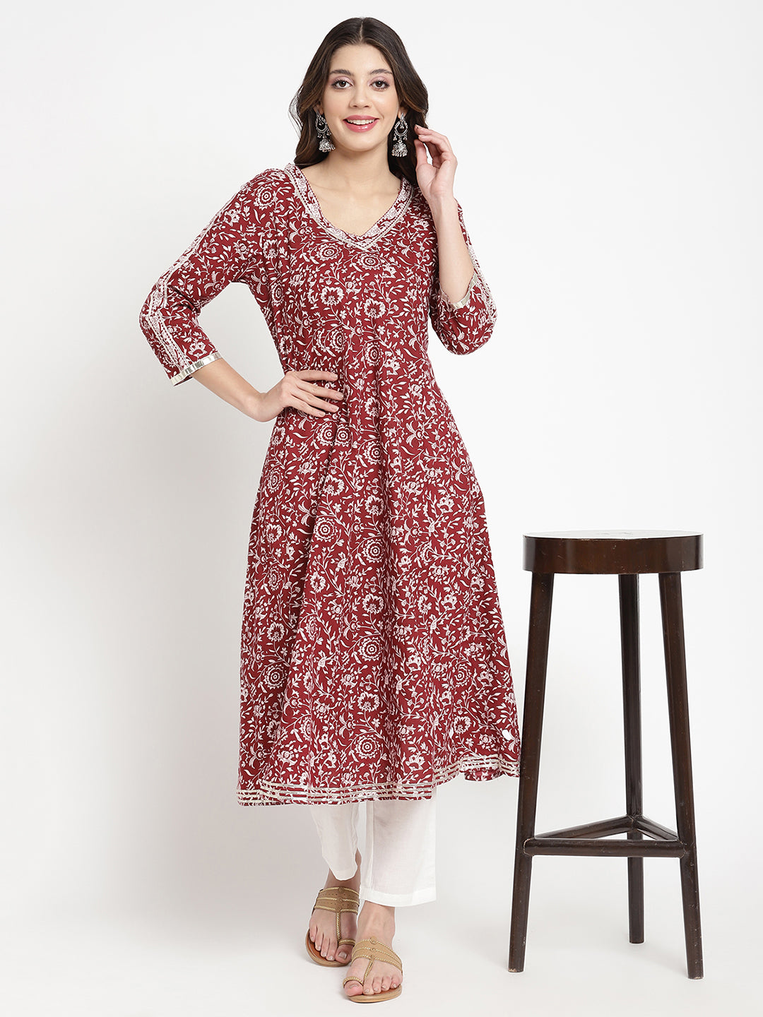 Woman posing in a flared Kurta against a white background.