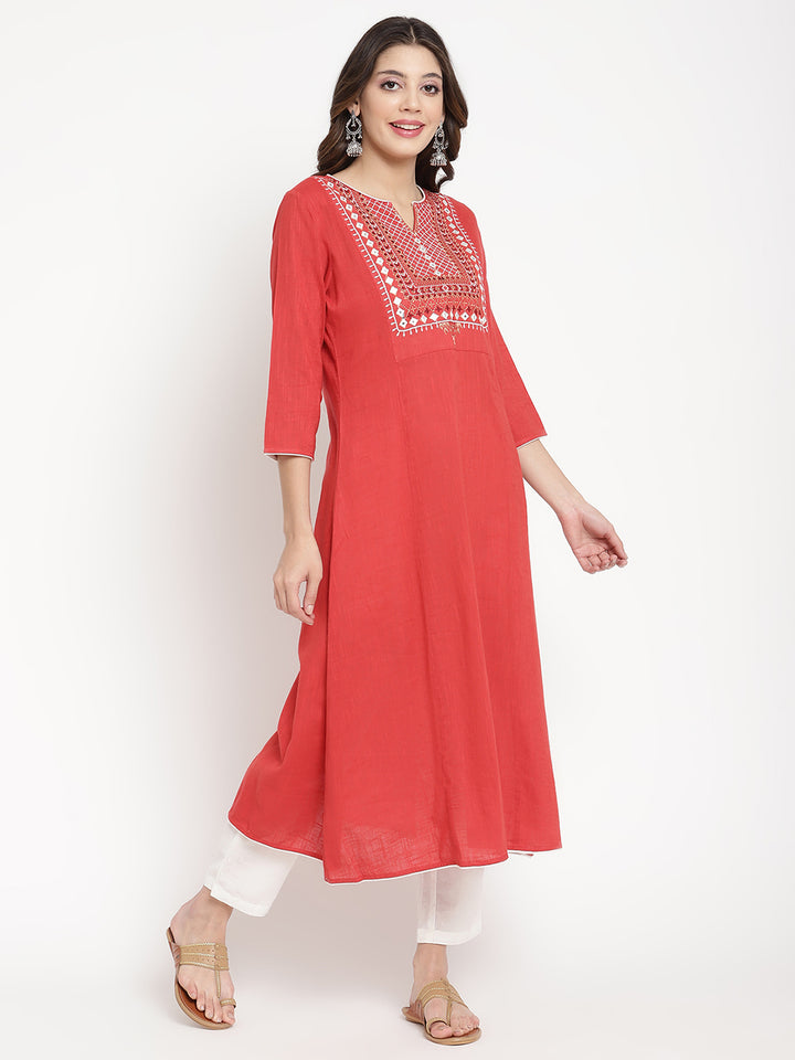 Woman wearing a red embroidered Kurta in an A-line silhouette.