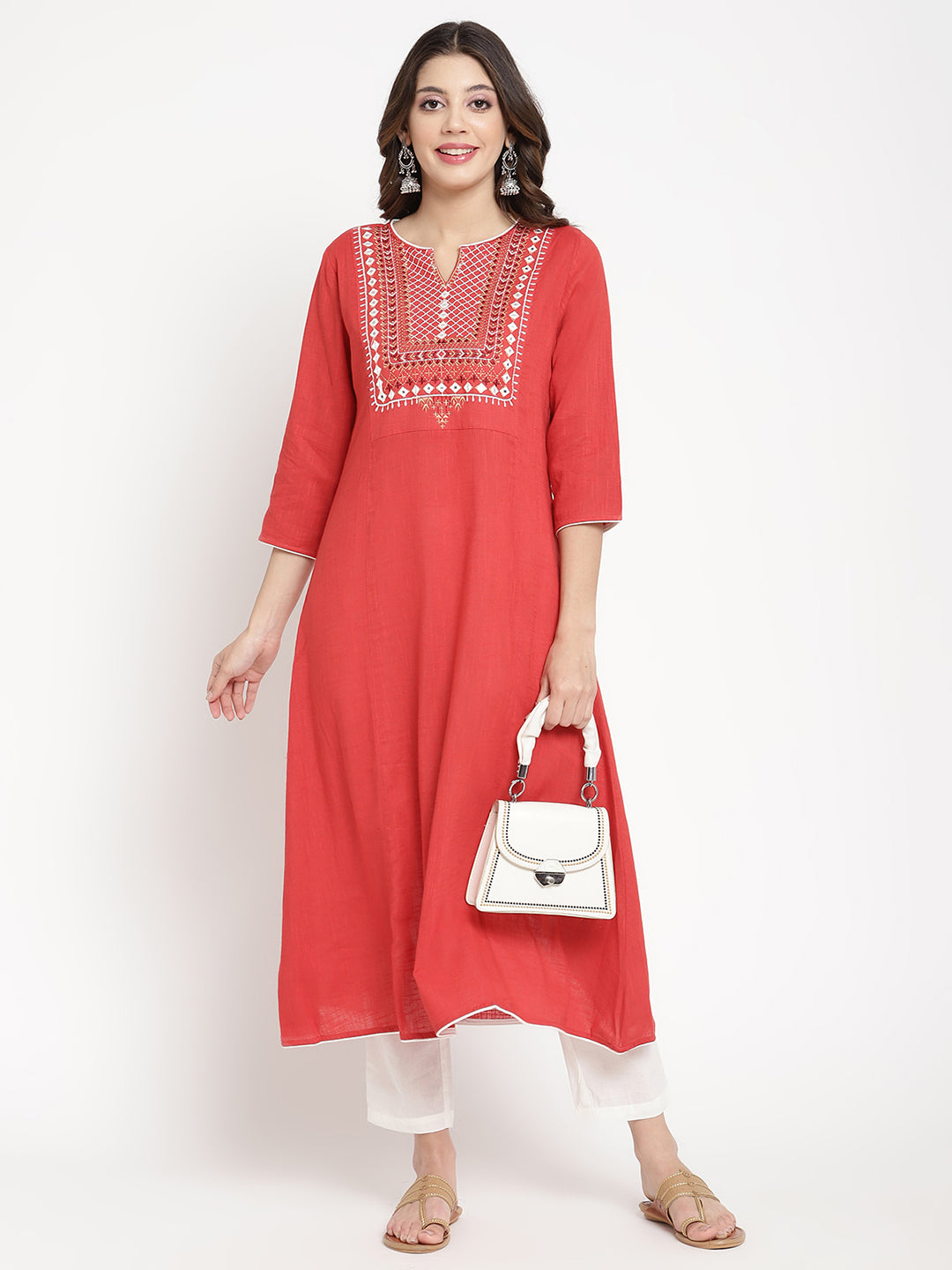Woman wearing a red embroidered Kurta in an A-line silhouette.