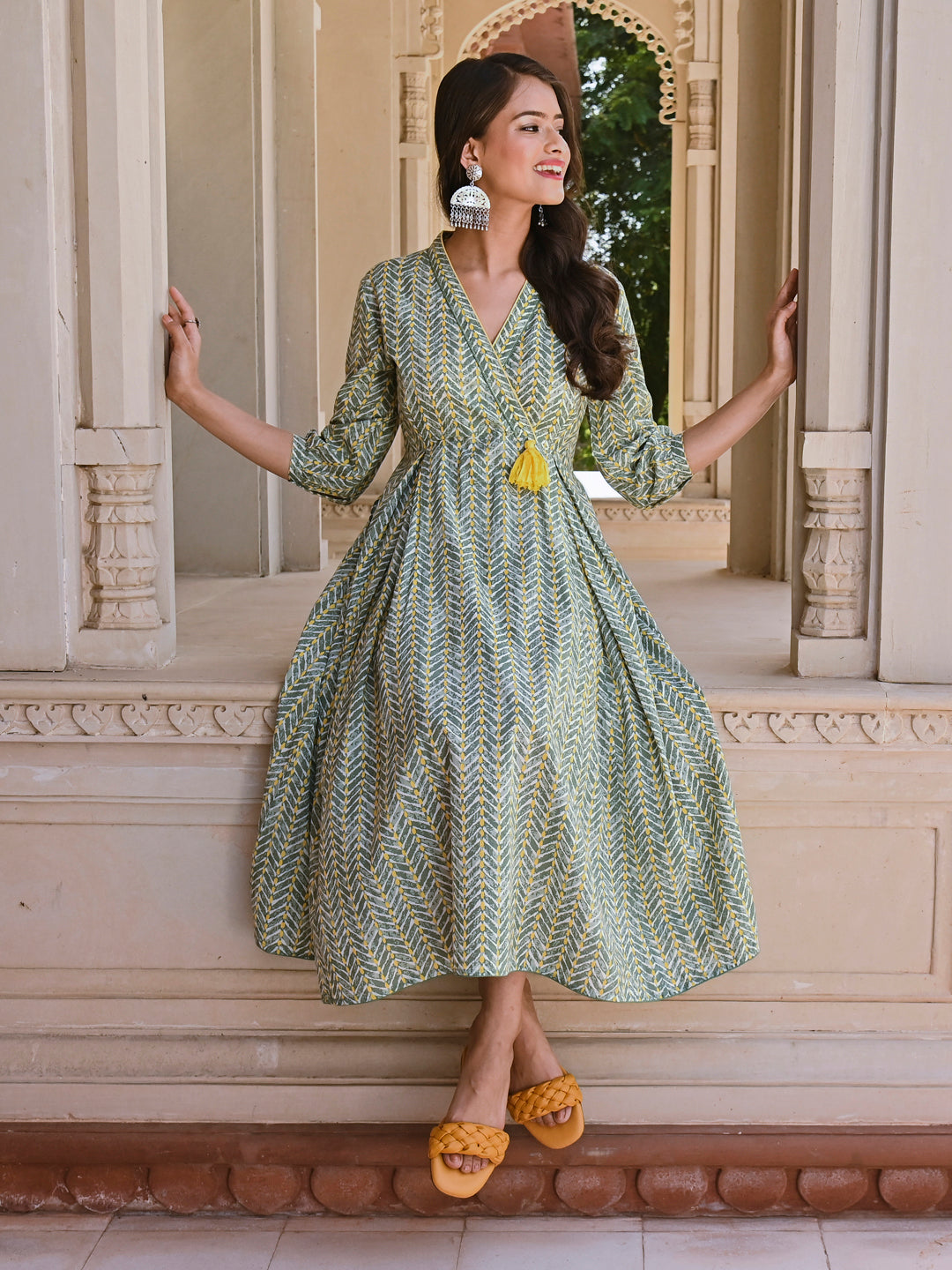 Woman posing in Savi's Cotton overlap Yoke sage Green Pleated Dress