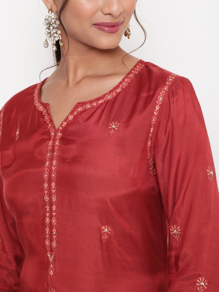 Woman posing in Savi’s Shantoon Embroidered Ethnic Rust Kurta with Contrast Pant Set