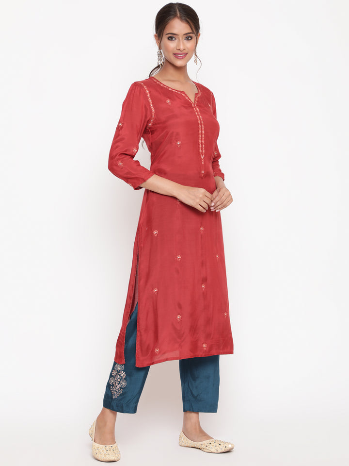 Woman posing in Savi’s Shantoon Embroidered Ethnic Rust Kurta with Contrast Pant Set